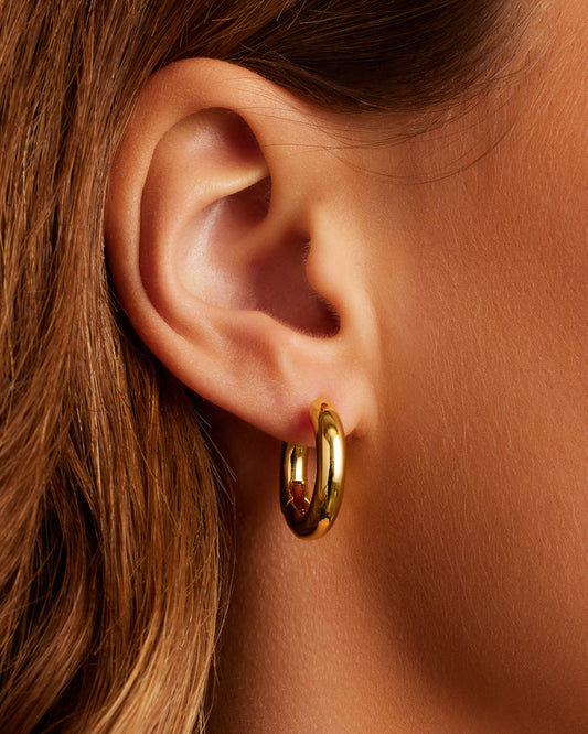 On model Lou Hoops chunky hoops bold hoop earrings || option::18K Gold Plated