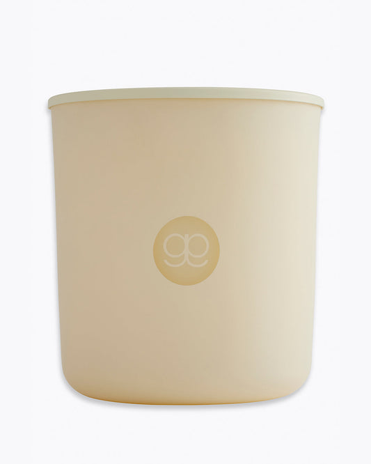 Beige candle with a logo on a white background